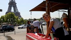 Image: Chaima Boutouil, 25, sells drinks and ice cream in view of the Eiffe