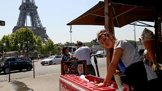 Image: Chaima Boutouil, 25, sells drinks and ice cream in view of the Eiffe