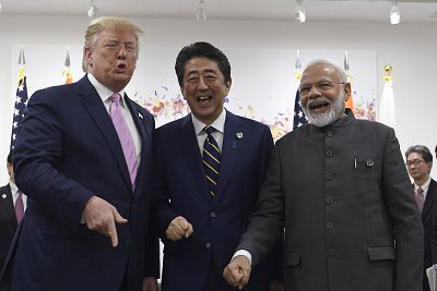 President Donald Trump, Japanese Prime Minister Shinzo Abe, center, and Indian Prime Minister Narendra Modi, right, share a laugh at the start of their meeting on the sidelines of the G-20 summit on Friday.