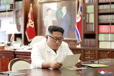 Kim Jong Un reads a letter from U.S. President Donald Trump on Saturday.
