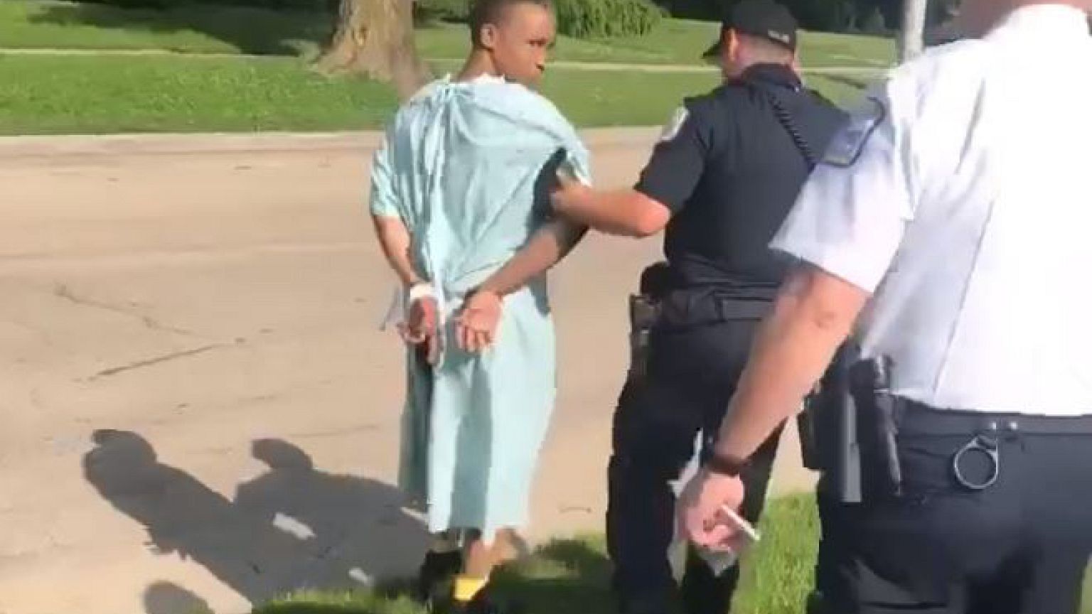 Shaquille Dukes is arrested by police in his hospital gown.
