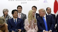 Image: President Donald Trump, right, leans over to talk to Ivanka Trump as