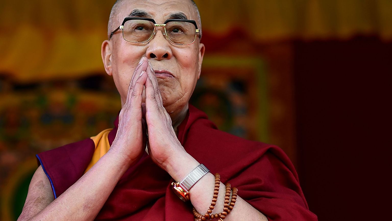 Image: The Dalai Lama taking to the stage to address the faithful in Alders
