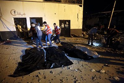 Emergency workers recover bodies after an airstrike killed dozens at Tajoura Detention Center near Tripoli on Wednesday.