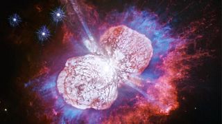 Eta Carinae, a distant star spouting twin nebulae of red, white and blue ga