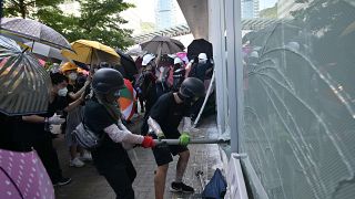 Image: Protesters attempt to break a window at the government headquarters 