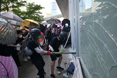 Protesters attempt to break a window at the government headquarters in Hong Kong on Monday.