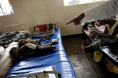 Two-year-old Elia, left, lies on a bed on Nov. 10, 2008, in the hospital of Rutshuru in the eastern Democratic Republic of Congo (DRC) after being treated for a gunshot wound to his arm.