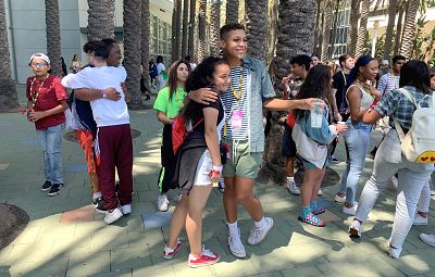 Isiah Perysian, right, takes a picture with a fan at VidCon in Anaheim, California, on July 10, 2019.