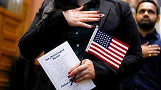 Image: A candidate for citizenship during a naturalization ceremony in Jers