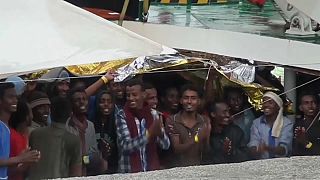 Migrants celebrate arrival in Italy