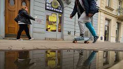 People pass in front of a Bitcoin exchange