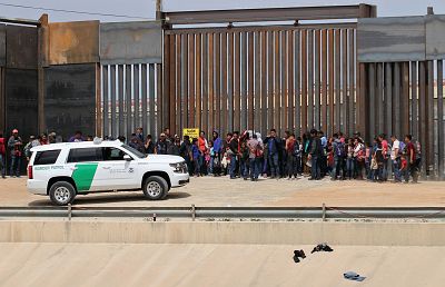 Central American migrants are detained by U.S. Customs and Border Patrol agents at the border wall in Ciudad Juarez, Chihuahua state, Mexico.