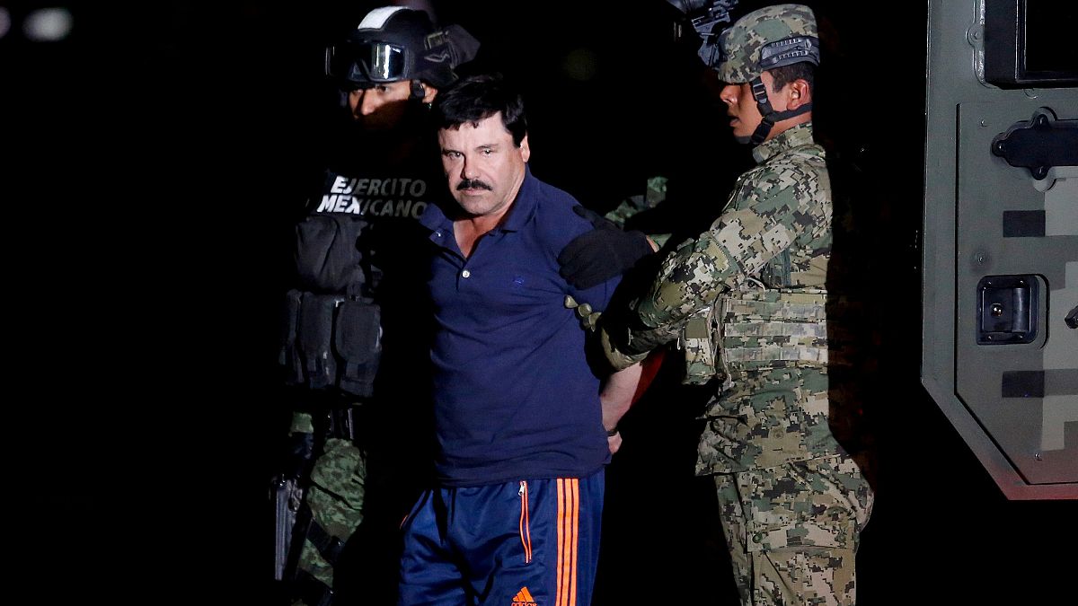 Image: Joaquin "El Chapo" Guzman is escorted by soldiers during a presentat