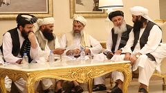 Image: Members of Afghan delegations gather in the Qatari capital Doha on J