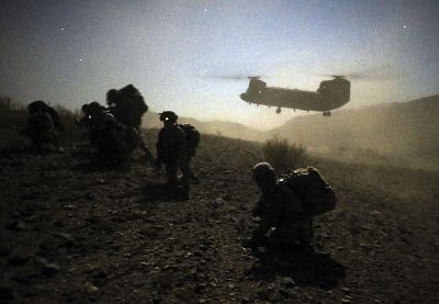 U.S. and Afghan soldiers take a knee near a U.S. Army Chinook during near the town of Walli Was in Paktika province Nov. 1, 2012.