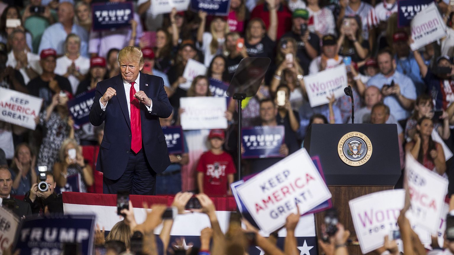 President Donald Trump takes the podium before speaking during a Keep Ameri