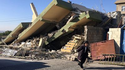 Cracks in the road and gutted houses in quake-hit eastern Iraq