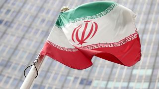 Image: The Iranian flag in front the International Atomic Energy Agency (IA