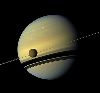 Saturn\'s largest moon, Titan, passes in front of the planet.
