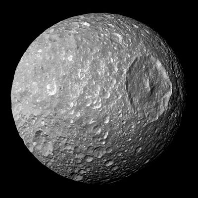 The prominent crater on the surface of Mimas, one of Saturn\'s moons, makes it look like the Death Star from the "Star Wars" saga.