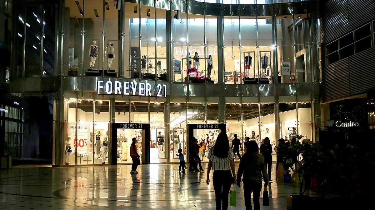 People walk next to Forever 21 store at Jockey Plaza Mall in Lima