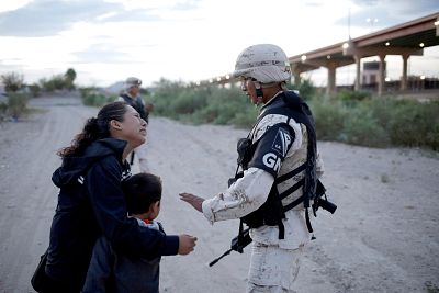 Guatemalan migrant Ledy Perez embraces her son Anthony while asking a member of the Mexican National Guard to let them cross into the United States, in Ciudad Juarez, Mexico on July 22, 2019.