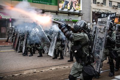Riot police fire tear gas towards protesters in the district of Yuen Long on Saturday in Hong Kong, China.