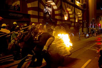 Protesters push a burning cart towards police at a demonstration in the Sheung Wan district of Hong Kong on July 28.