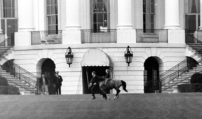 Caroline Kennedy rides her pony, Macaroni, on the south grounds of the White House on March 20, 1962.