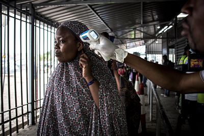 A woman gets her temperature measured at an Ebola screening station as she enters the Democratic Republic of the Congo from Rwanda in Goma on July 16.