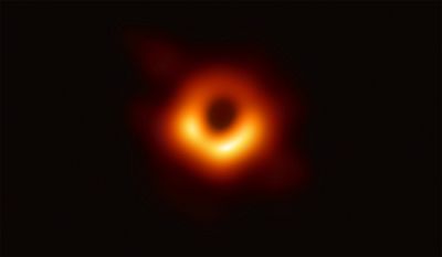 The first-ever image of a black hole, the dark circle surrounded by a swirling cloud of hot gas.