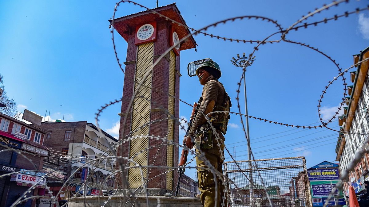 Image: An Indian army soldier stands guard in front of the clock tower duri