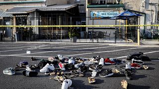 Image: A pile of shoes outside the scene of a mass shooting at Ned Peppers