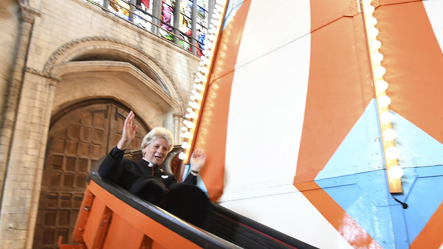 Image: The Very Reverend Jane Hedges slides down the helter skelter inside 