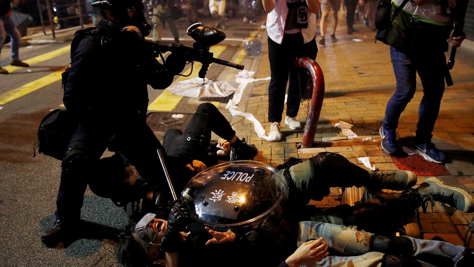 Image: Police detain a demonstrator during a protest against police violenc