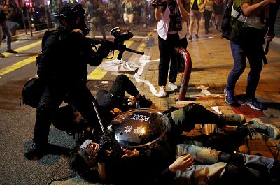 Police detain a demonstrator during a protest against police violence on July 28.
