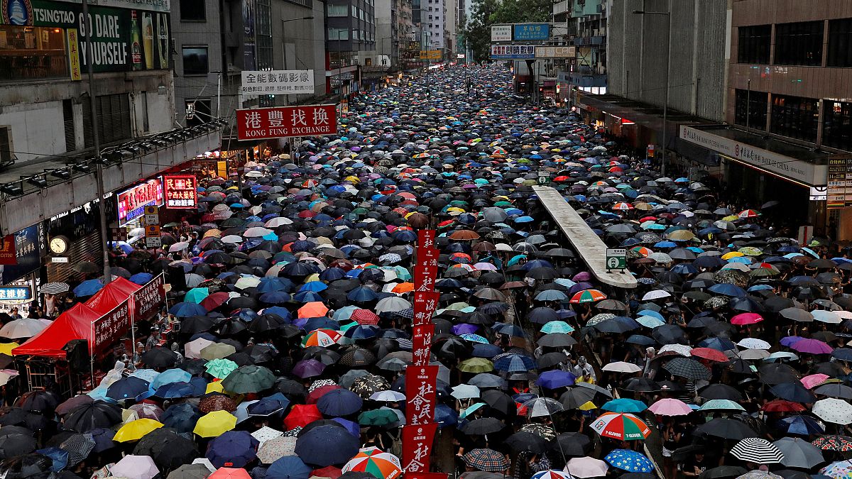 Image: People march during a rally to demand democracy and political reform