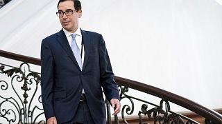 Image: Treasury Secretary Steven Mnuchin walks to a breakfast at the G7 Sum