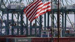 Image: The U.S. flag flies over Chinese shipping containers that were unloa