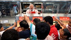 Image: People try to get a roast chicken at the first Costco outlet in Chin