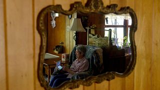 Image: Audrey Buchanan, 88, is reflected in a mirror while she plays Animal