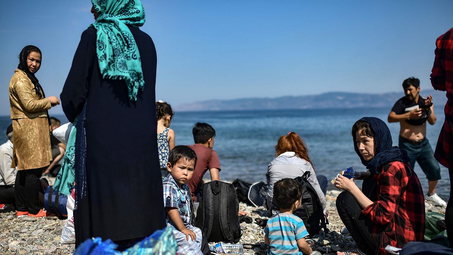 Image: Migrants from Afghanistan arrive after crossing the Aegean Sea from 