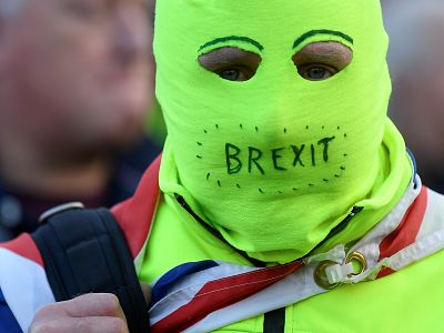 A pro-Brexit protester with a face mask looks on at the March to Leave demonstration in London on March 29.