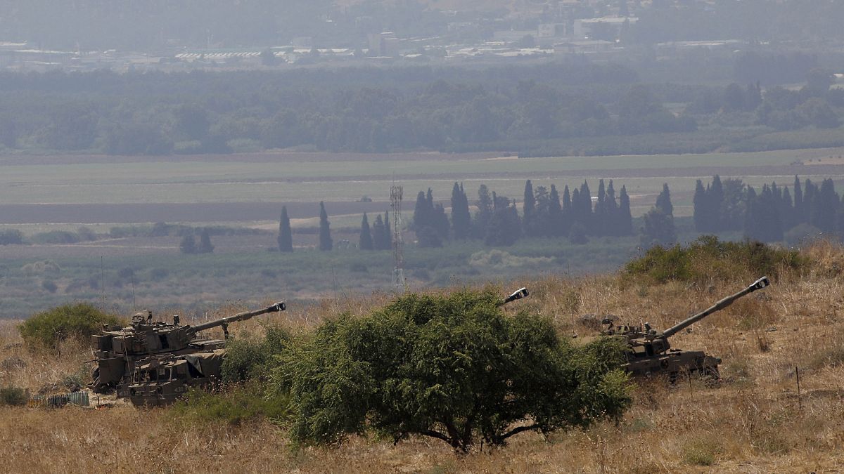 Image: Israeli self-propelled artillery guns are positioned near the Lebane