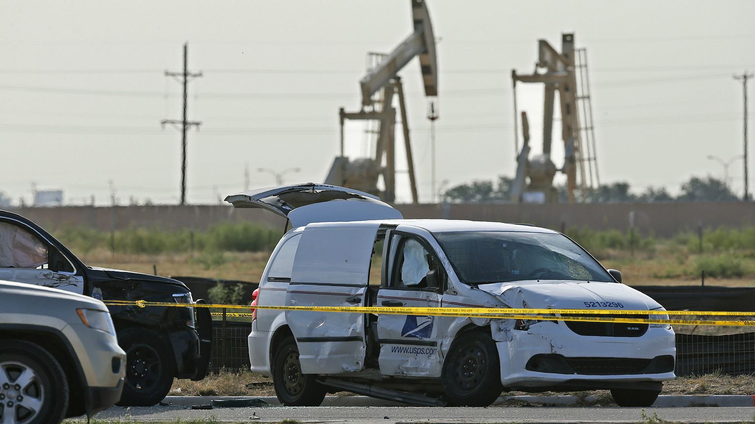 Image: A U.S. Mail vehicle, right, which was involved in Saturday's shootin