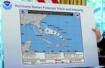 Image: President Donald Trump holds an early projection map in the Oval Off