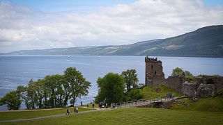 Image: Tourists take in Urquhart Castle on the banks of Loch Ness in the Sc