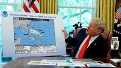 Image: UPresident Donald Trump holds an early projection map of Hurricane D