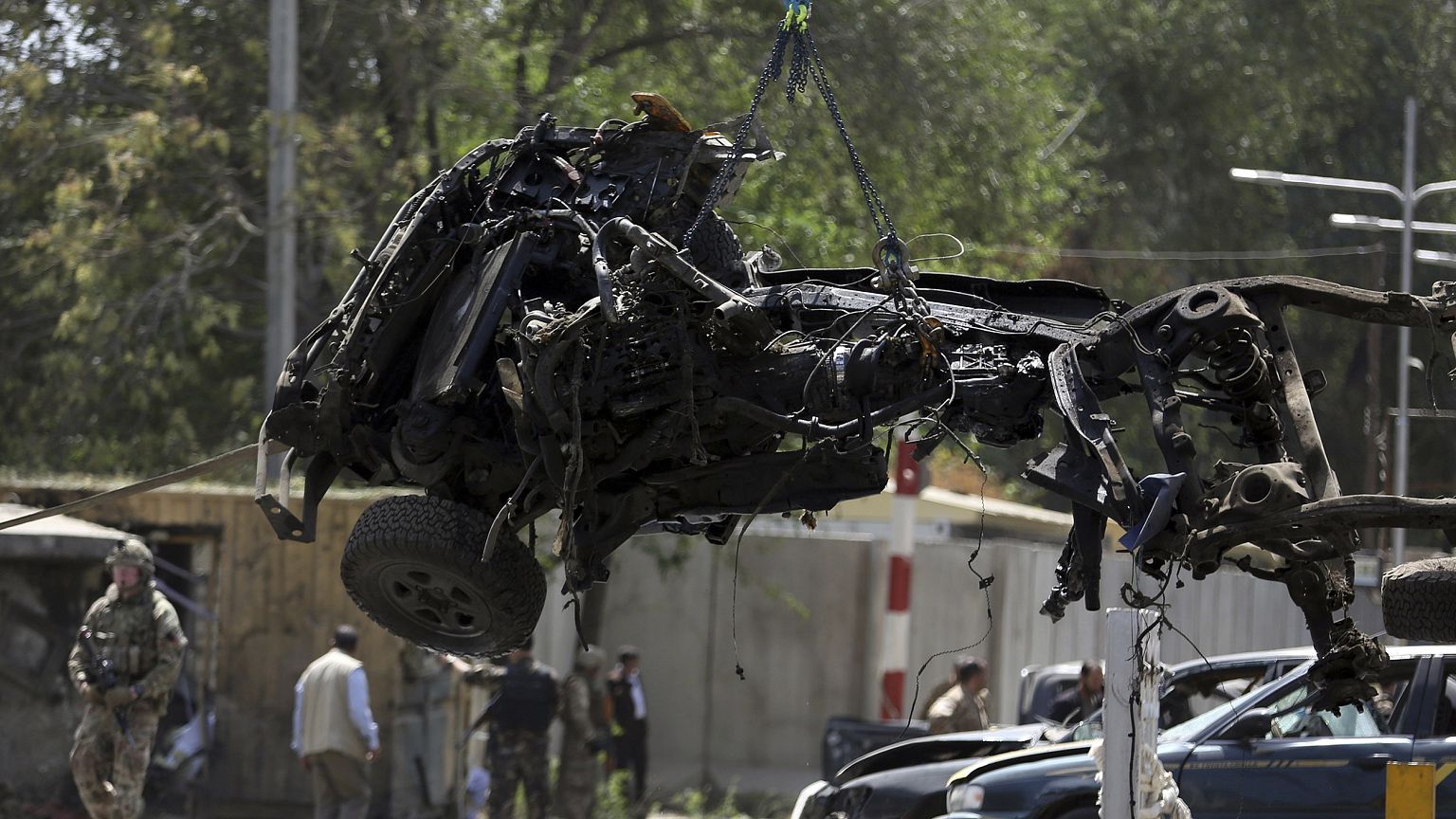 Image: Resolute Support (RS) forces remove a destroyed vehicle after a car 